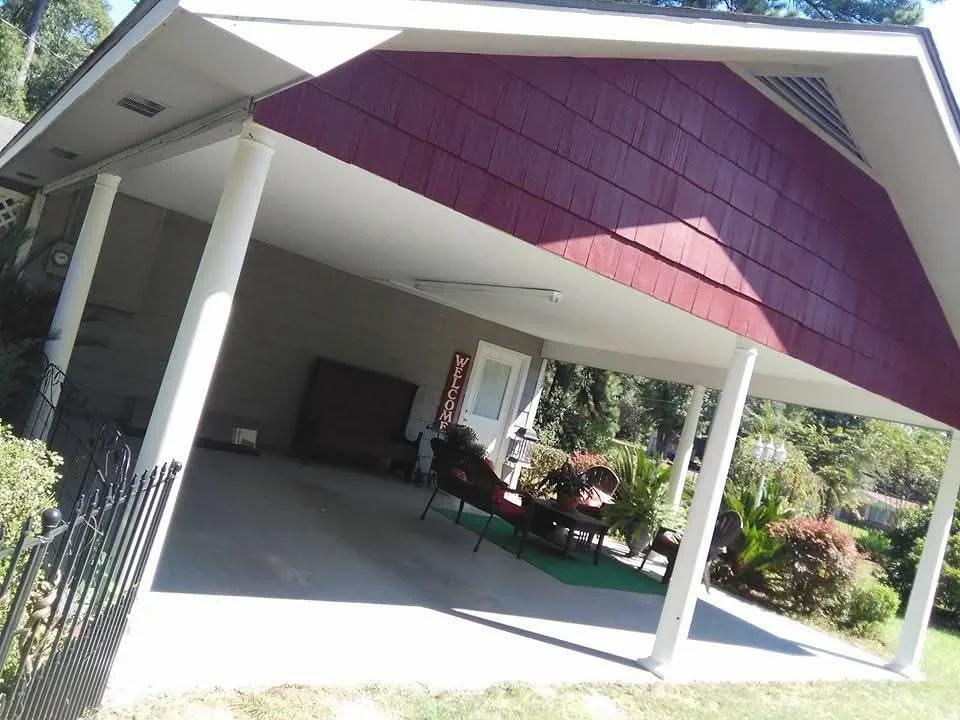White painted porch with burgundy gable end, white columns and trim, residential exterior painting