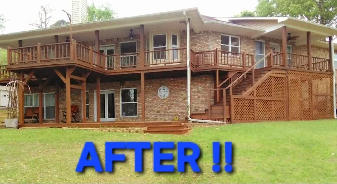 Brick home with multi-level wood decks, railings, and lattice screening after staining and finishing