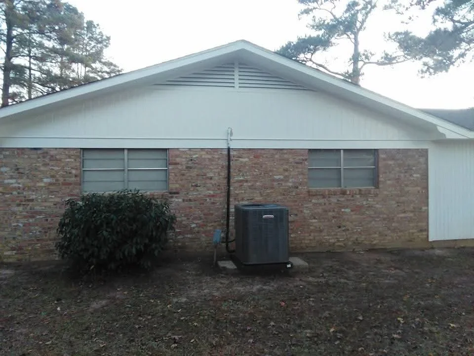White painted gable and trim on brick residential home exterior