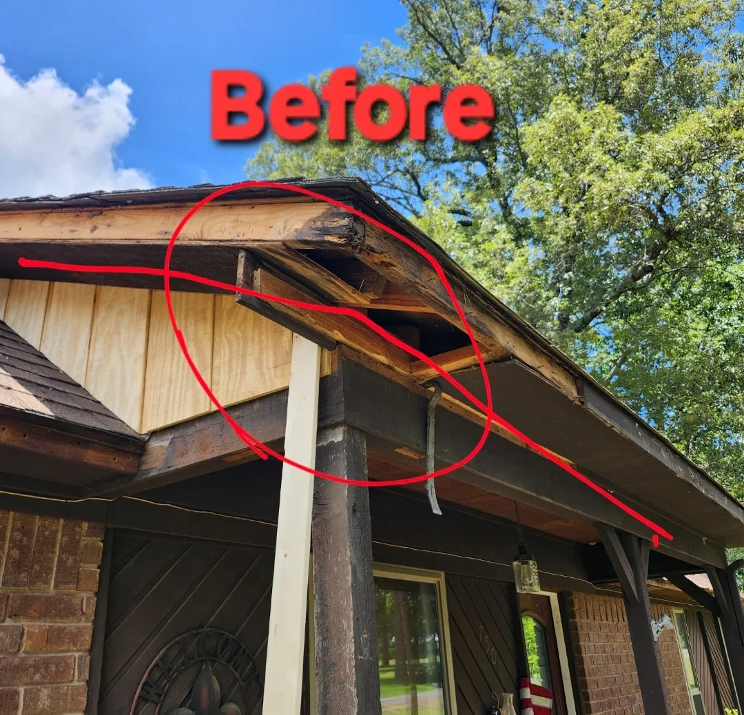 Damaged wooden soffit and fascia with rot and deterioration marked for repair