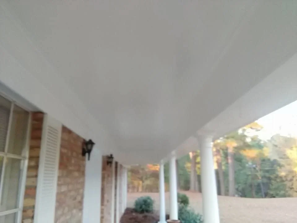 White painted soffit, fascia, and porch ceiling with brick exterior and white columns