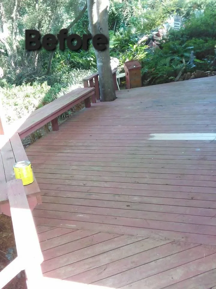 Burgundy-stained wooden deck with matching railings and linear board pattern