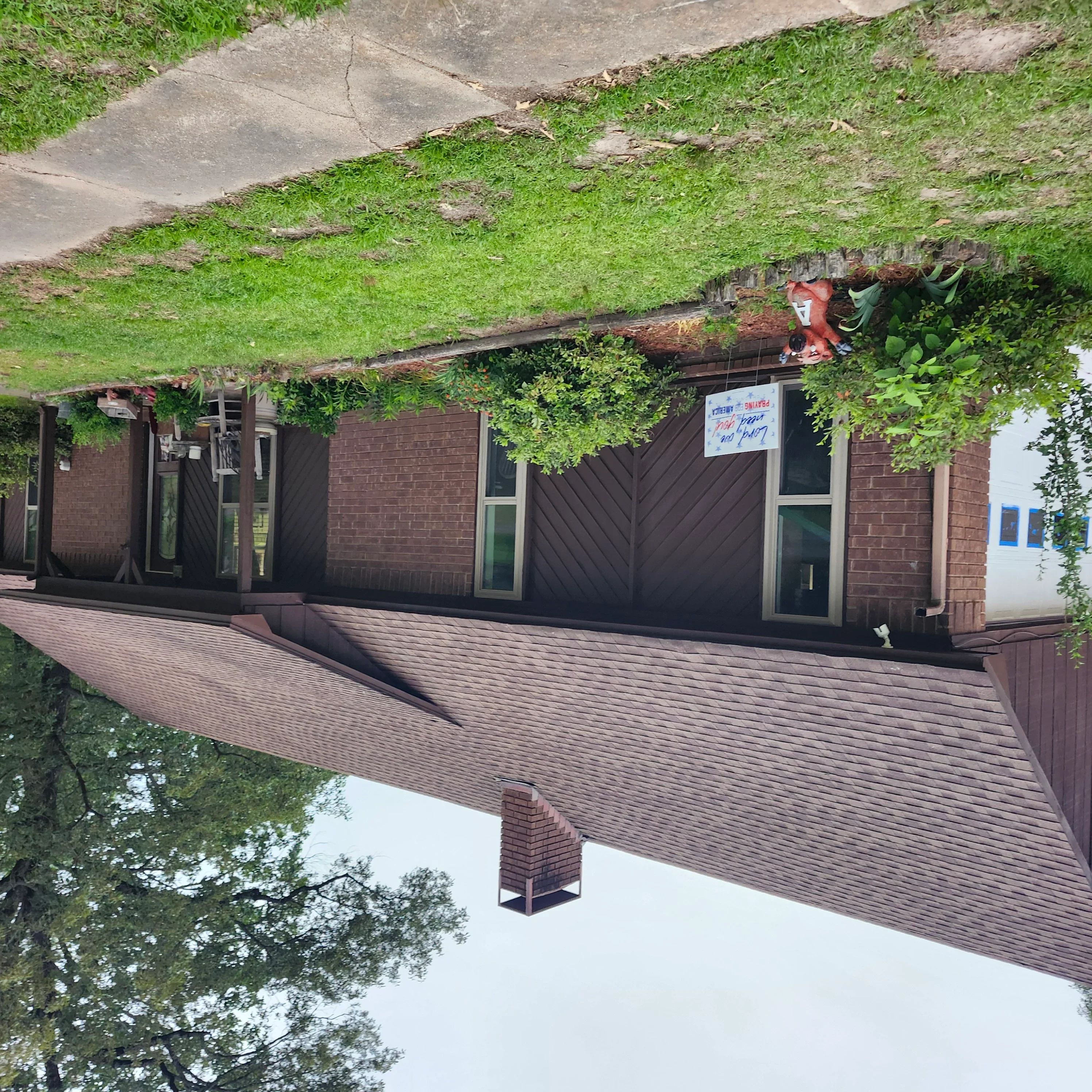 Dark painted garage doors and brick exterior with fresh paint on residential home trim